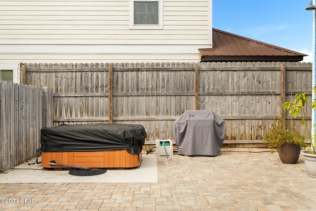 view of patio featuring area for grilling and a hot tub