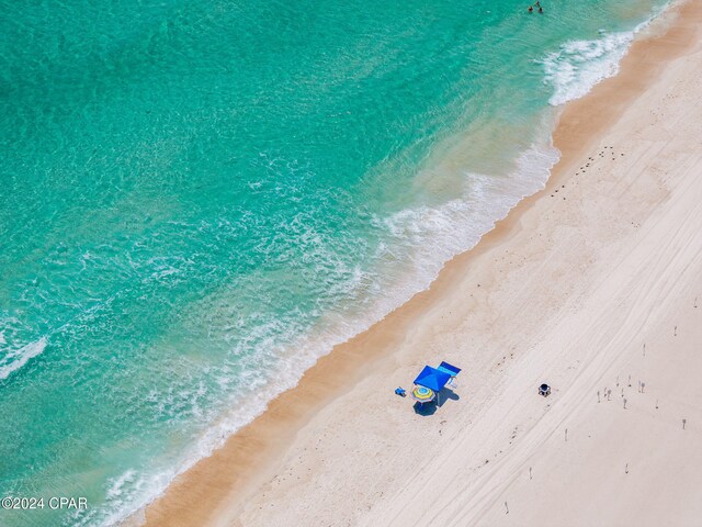 birds eye view of property with a beach view and a water view