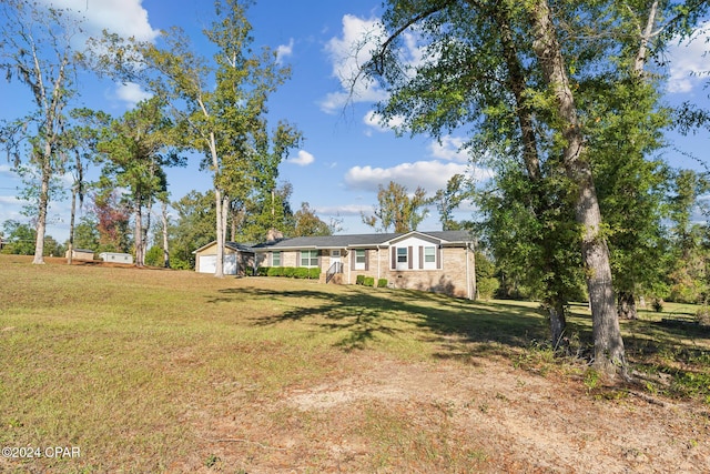 view of front of property with a garage and a front lawn