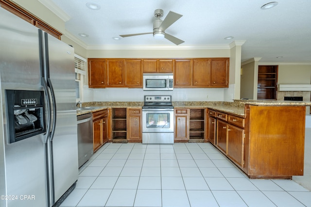 kitchen featuring kitchen peninsula, appliances with stainless steel finishes, light stone countertops, ornamental molding, and ceiling fan