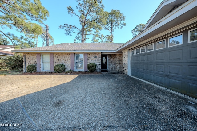 ranch-style home featuring a garage