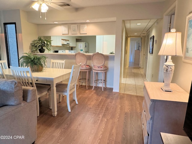 dining space featuring ceiling fan and hardwood / wood-style floors