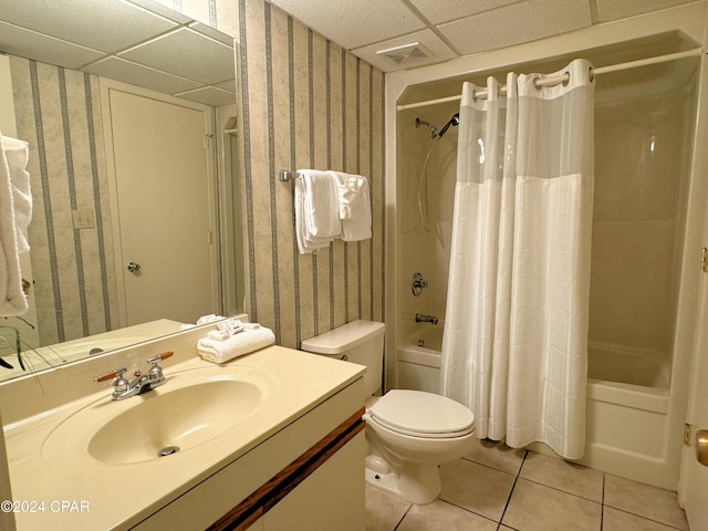 full bathroom featuring tile patterned flooring, vanity, toilet, and shower / bath combo with shower curtain