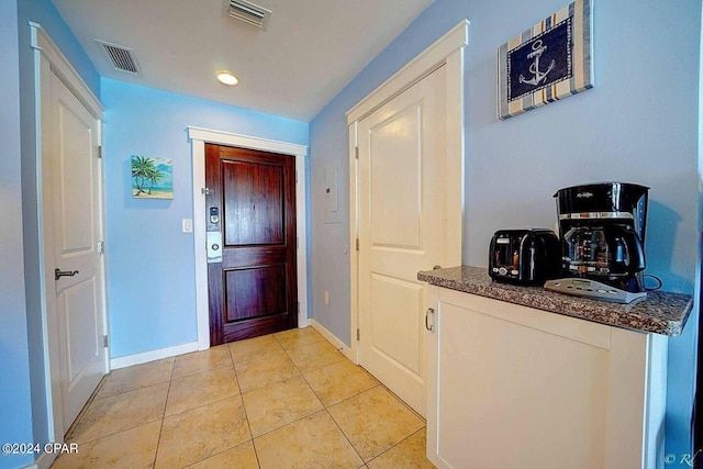 doorway featuring light tile patterned flooring