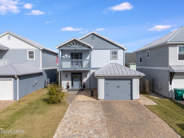 view of front of house featuring a front lawn, a garage, and a balcony