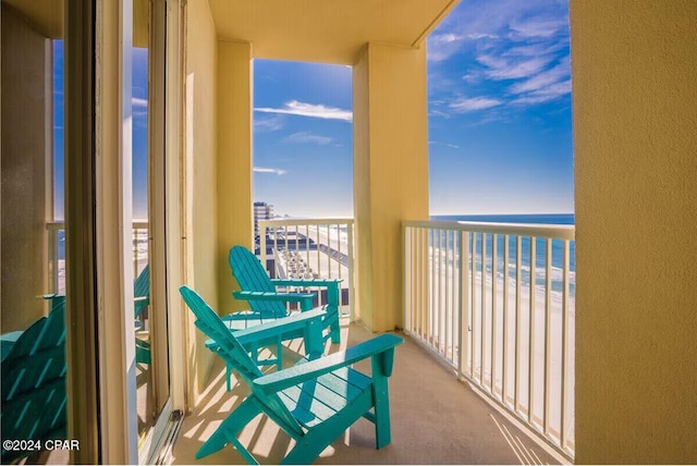 balcony with a view of the beach and a water view