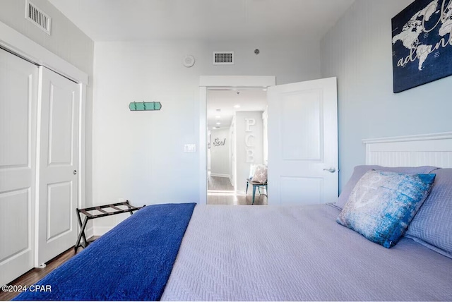 bedroom featuring hardwood / wood-style floors and a closet