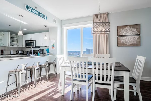 dining area with hardwood / wood-style flooring and sink