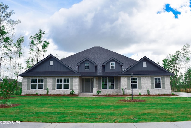 craftsman-style home featuring brick siding, roof with shingles, and a front yard