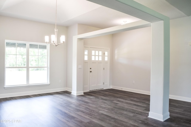 entryway with a chandelier, dark wood-type flooring, and baseboards