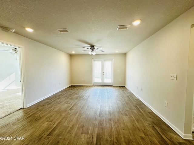 unfurnished room with french doors, dark hardwood / wood-style flooring, a textured ceiling, and ceiling fan