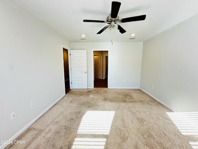 unfurnished bedroom with light colored carpet and ceiling fan