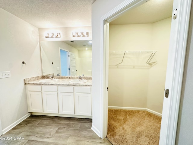 bathroom featuring vanity and a textured ceiling