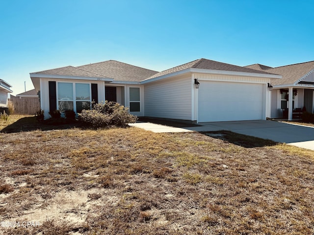 ranch-style house with a garage and a front lawn