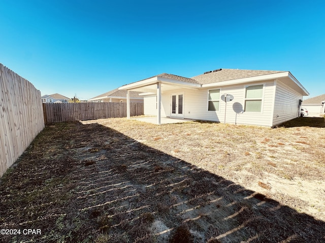 rear view of property with french doors and a patio