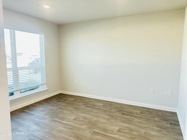 unfurnished room featuring hardwood / wood-style flooring