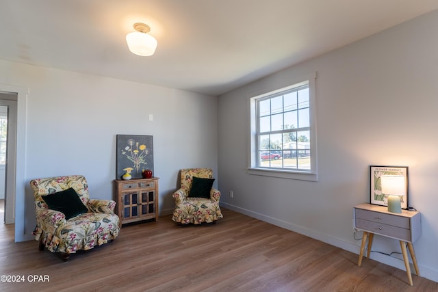 sitting room with wood finished floors and baseboards