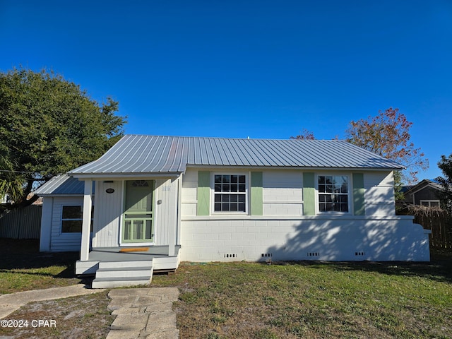 view of front of property with crawl space, a front lawn, metal roof, and entry steps