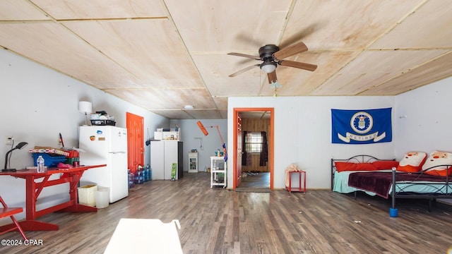 interior space with dark hardwood / wood-style flooring, white fridge, and ceiling fan