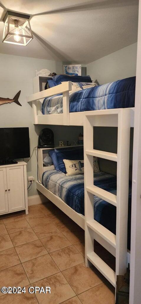 bedroom with light tile patterned floors