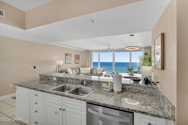 kitchen with ceiling fan, pendant lighting, stainless steel dishwasher, sink, and white cabinets