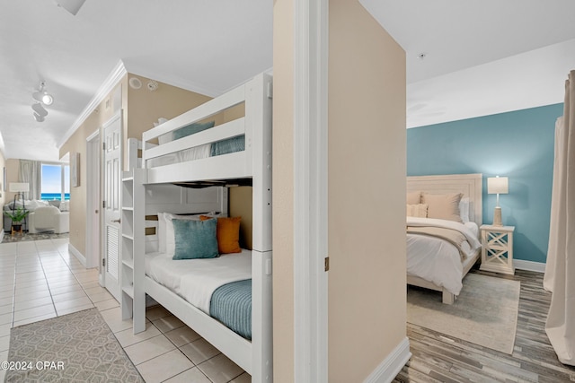 tiled bedroom with baseboards and ornamental molding