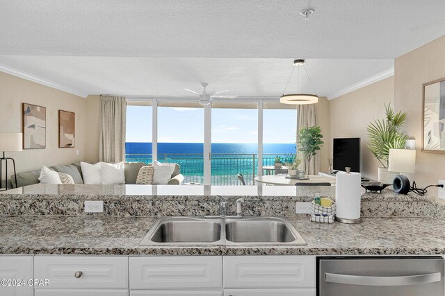 kitchen with ceiling fan, decorative light fixtures, stainless steel dishwasher, sink, and white cabinets