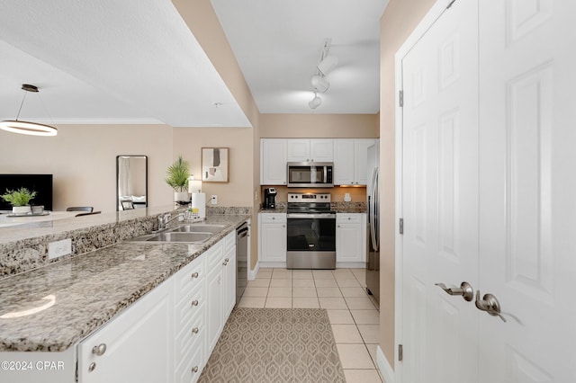 kitchen featuring light tile patterned floors, sink, stainless steel appliances, and white cabinetry