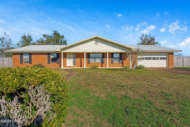 single story home with a front yard and a garage