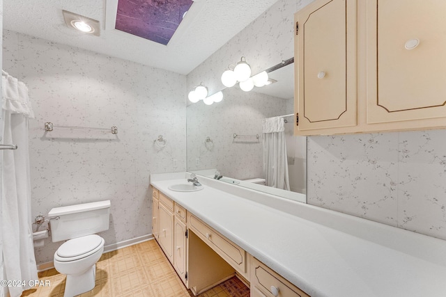 bathroom with a shower with shower curtain, vanity, toilet, and a textured ceiling