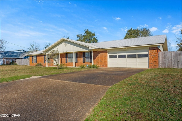 ranch-style house featuring a front yard and a garage