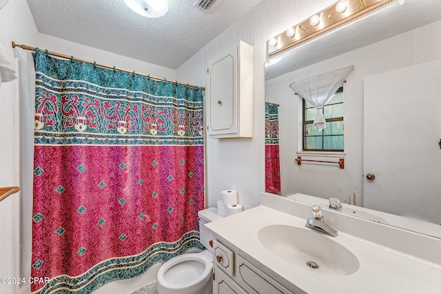 bathroom with vanity, a textured ceiling, and toilet