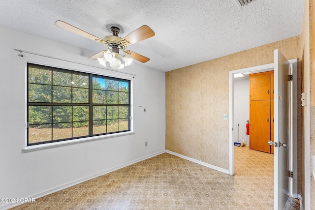 unfurnished room featuring ceiling fan and a textured ceiling