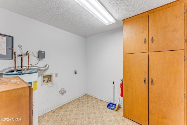 laundry room featuring cabinets, washer hookup, electric water heater, and a textured ceiling