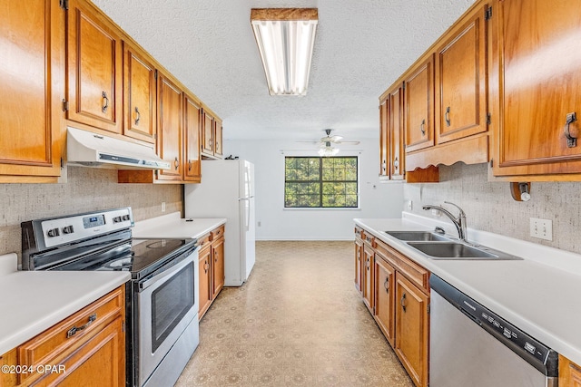 kitchen featuring a textured ceiling, ceiling fan, sink, and stainless steel appliances