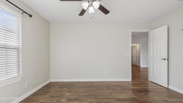 spare room with ceiling fan and dark wood-type flooring