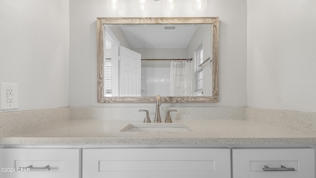 bathroom with a shower with curtain and vanity