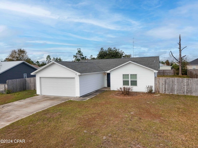 single story home featuring a garage and a front lawn