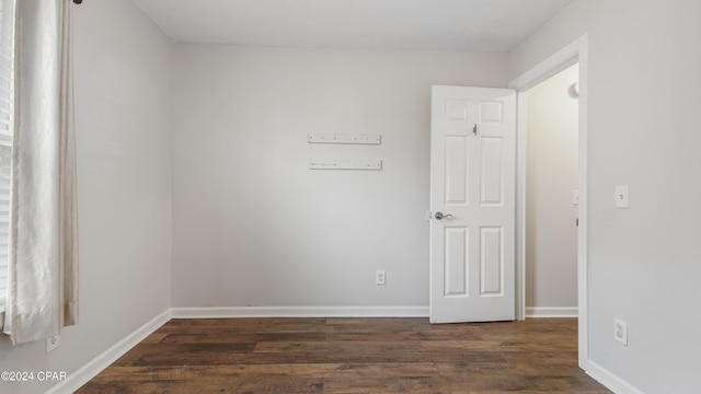 spare room with dark hardwood / wood-style floors