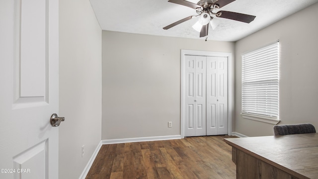 unfurnished office with ceiling fan and wood-type flooring