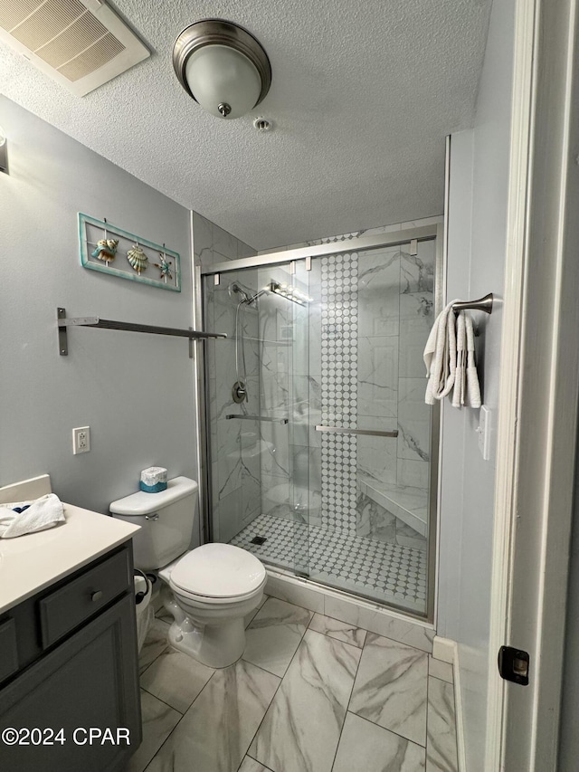 bathroom featuring a textured ceiling, vanity, toilet, and walk in shower