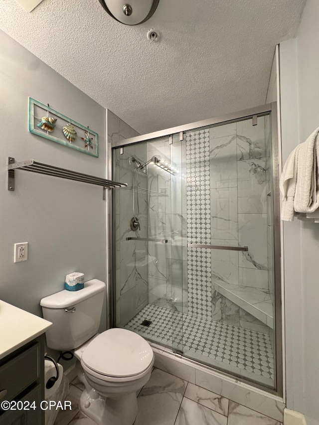 bathroom featuring vanity, an enclosed shower, and a textured ceiling