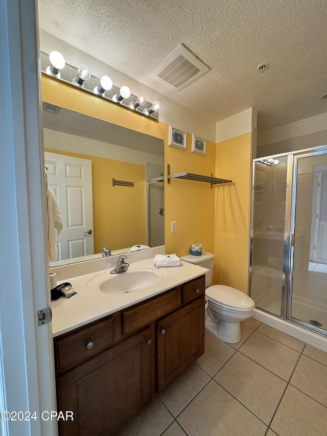 bathroom with tile patterned flooring, vanity, and a shower with shower door