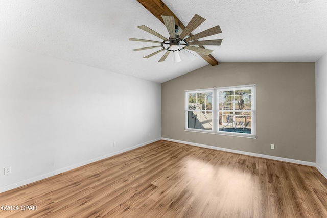 unfurnished room with hardwood / wood-style floors, vaulted ceiling with beams, ceiling fan, and a textured ceiling