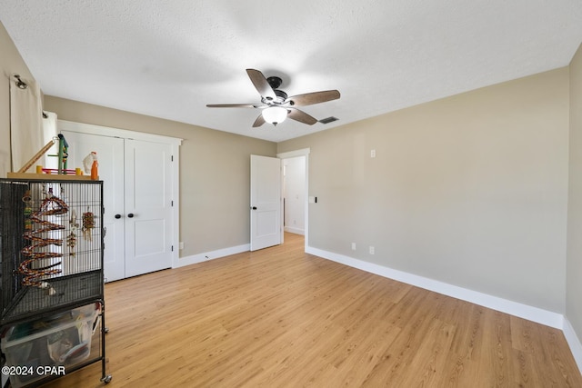 unfurnished bedroom featuring light hardwood / wood-style floors and a textured ceiling