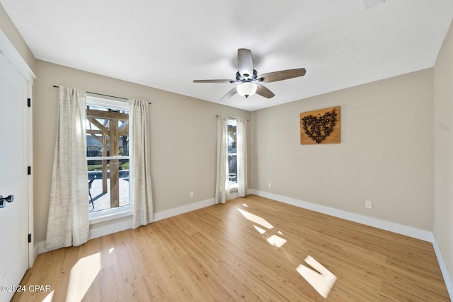 unfurnished room featuring ceiling fan, light hardwood / wood-style flooring, and plenty of natural light