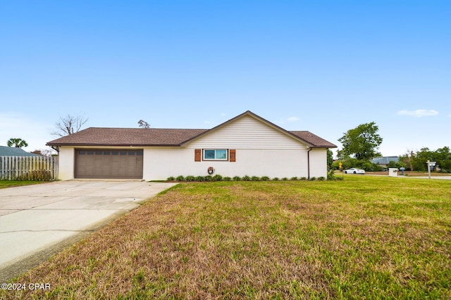 ranch-style house with a front lawn and a garage