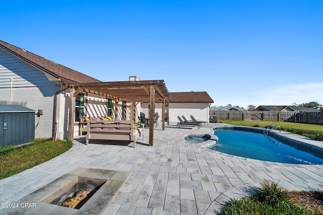 view of swimming pool featuring an in ground hot tub, a pergola, an outdoor fire pit, and a patio area