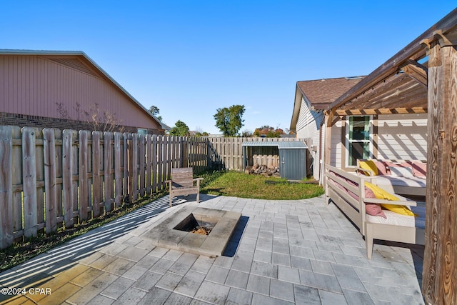 view of patio featuring a pergola and a fire pit