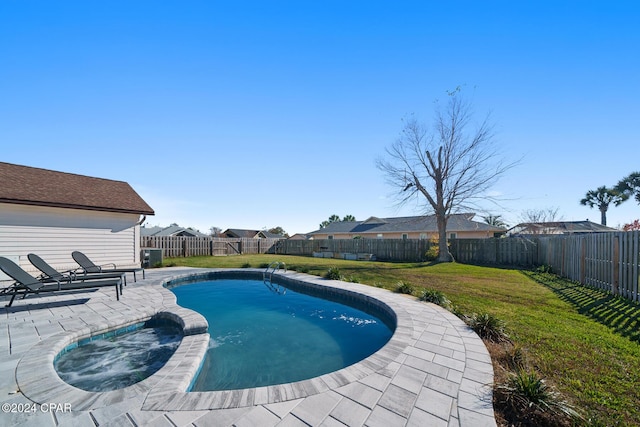 view of pool with an in ground hot tub, a patio area, and a lawn